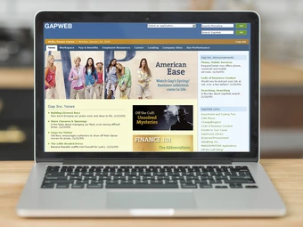 laptop computer on desk with intranet portal website showing